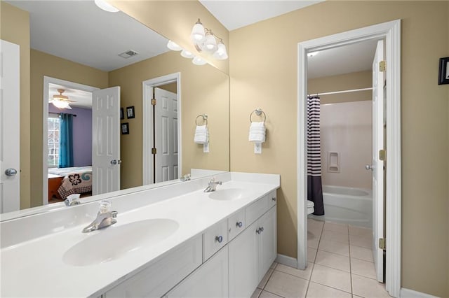 full bathroom featuring ceiling fan, tile patterned flooring, toilet, vanity, and shower / tub combo