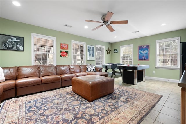 living room with light tile patterned floors and ceiling fan