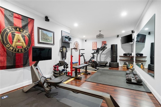 workout area with crown molding and hardwood / wood-style floors