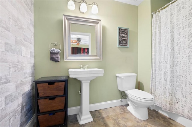 bathroom with tile patterned floors, toilet, tile walls, and a shower with curtain