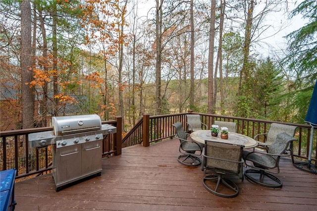 wooden terrace featuring a grill