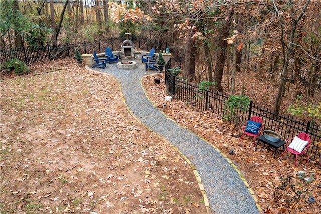 view of yard featuring an outdoor fireplace