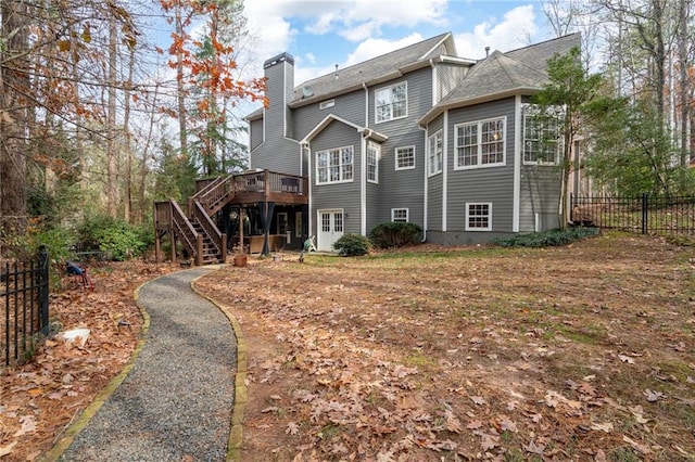 back of property featuring a wooden deck