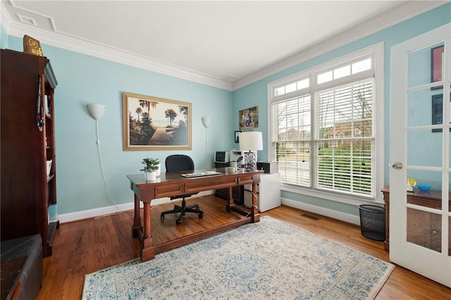 home office featuring hardwood / wood-style floors and crown molding