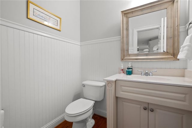 bathroom featuring vanity, toilet, and wood-type flooring