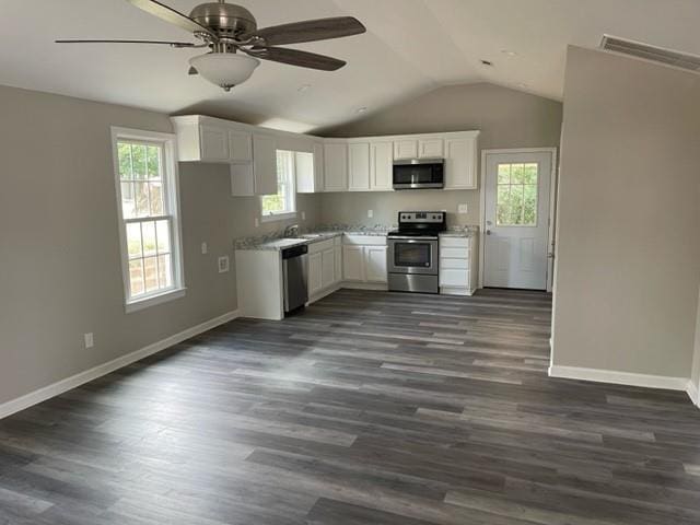 kitchen with ceiling fan, appliances with stainless steel finishes, sink, white cabinetry, and dark hardwood / wood-style floors