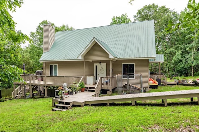1182 Cedar Rd, Lincolnton, GA 30817 - view of front of house with a front yard, a wooden deck, a chimney, and metal roof