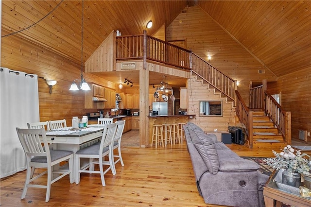 1182 Cedar Rd, Lincolnton, GA 30817 - dining area with wooden walls, wooden ceiling, high vaulted ceiling, stairway, and light wood-style floors