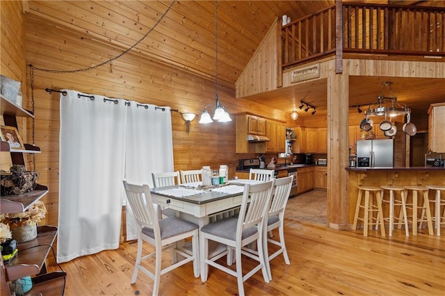 1182 Cedar Rd, Lincolnton, GA 30817 - dining area featuring a chandelier, wooden ceiling, wooden walls, high vaulted ceiling, and light wood-style flooring