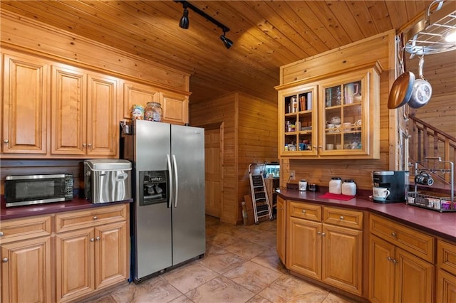 1182 Cedar Rd, Lincolnton, GA 30817 - kitchen with appliances with stainless steel finishes, wooden walls, dark countertops, track lighting, and glass insert cabinets