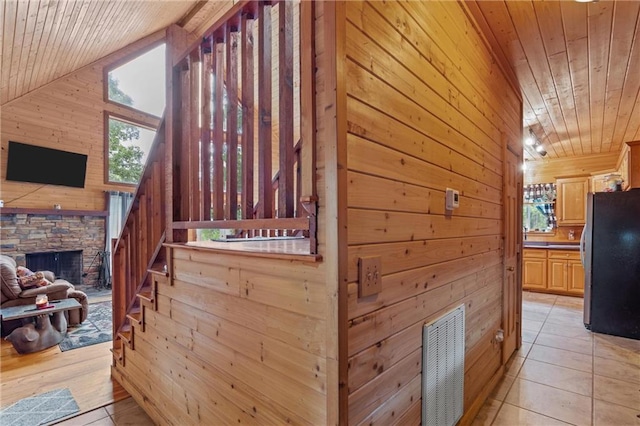 1182 Cedar Rd, Lincolnton, GA 30817 - corridor featuring wooden ceiling, wooden walls, plenty of natural light, lofted ceiling, and light tile patterned floors