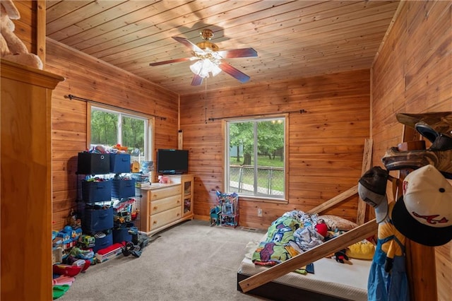 1182 Cedar Rd, Lincolnton, GA 30817 - carpeted bedroom featuring multiple windows, wood ceiling, wooden walls, and ceiling fan