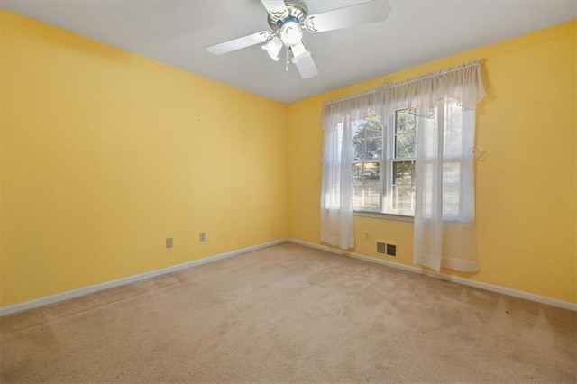 unfurnished room with ceiling fan and carpet flooring