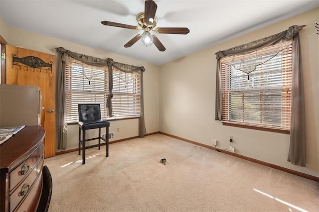 misc room with ceiling fan, a wealth of natural light, and light carpet