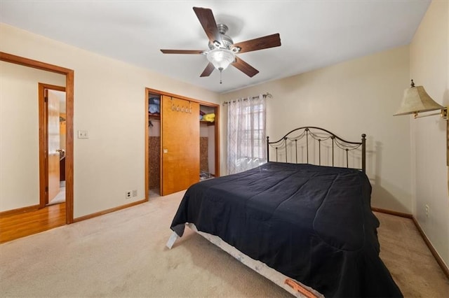 carpeted bedroom with ceiling fan and a closet