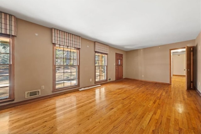 spare room with light hardwood / wood-style floors