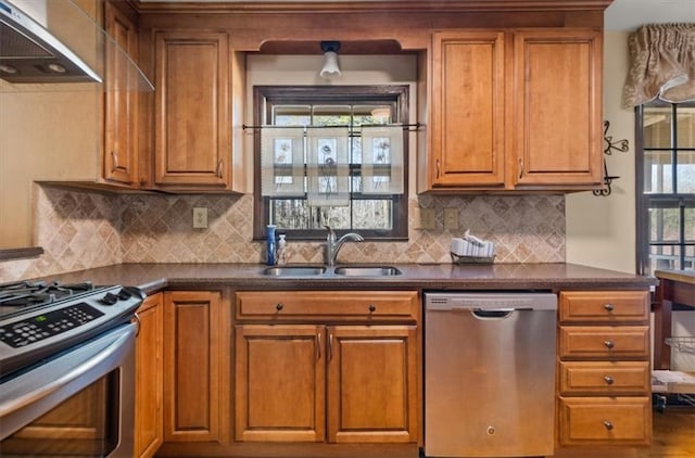 kitchen with decorative backsplash, sink, wall chimney range hood, and stainless steel appliances