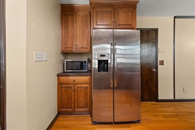 kitchen with stainless steel appliances and light hardwood / wood-style floors