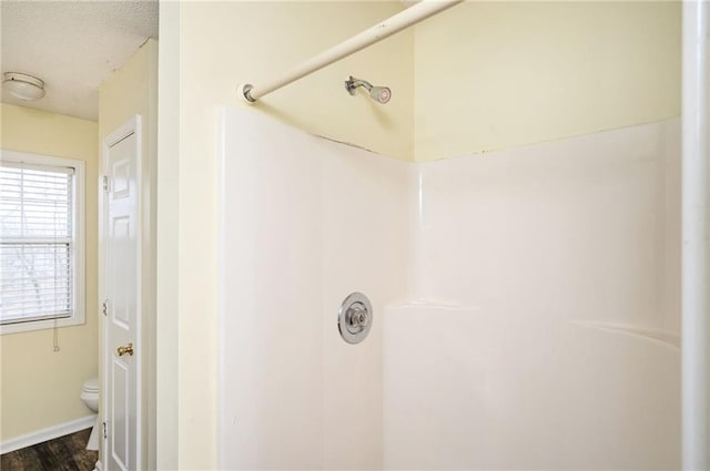 4157 Lake Mist Dr NW, Kennesaw, GA 30144 - bathroom featuring wood finished floors, toilet, baseboards, walk in shower, and a textured ceiling