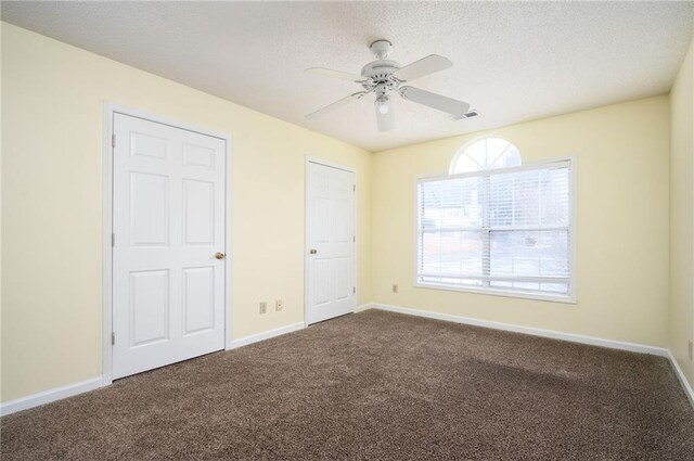 4157 Lake Mist Dr NW, Kennesaw, GA 30144 - unfurnished bedroom with visible vents, baseboards, a textured ceiling, a ceiling fan, and carpet