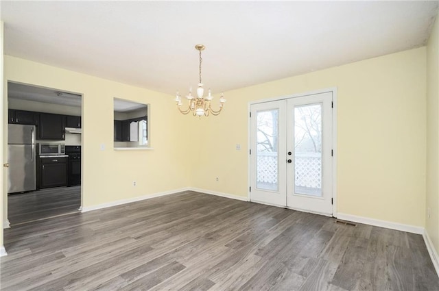 4157 Lake Mist Dr NW, Kennesaw, GA 30144 - unfurnished dining area featuring french doors, baseboards, wood finished floors, and a chandelier