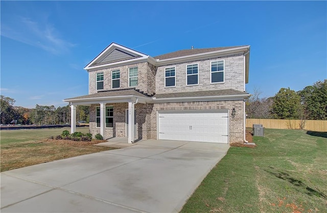 view of front of house with a garage, covered porch, and a front yard