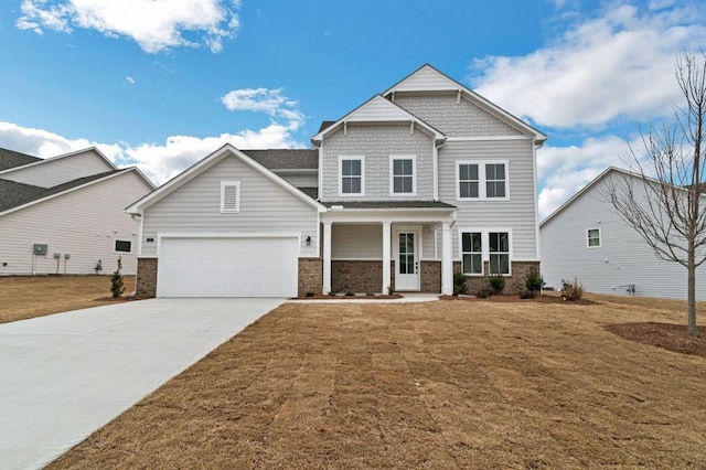 craftsman house featuring a garage and a front yard