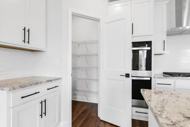 39 Pecan Ct, Hoschton, GA 30548 - laundry area with hookup for a washing machine, electric dryer hookup, cabinets, and dark hardwood / wood-style flooring
