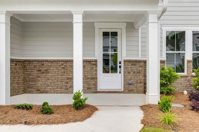 39 Pecan Ct, Hoschton, GA 30548 - entrance to property featuring brick siding and a porch