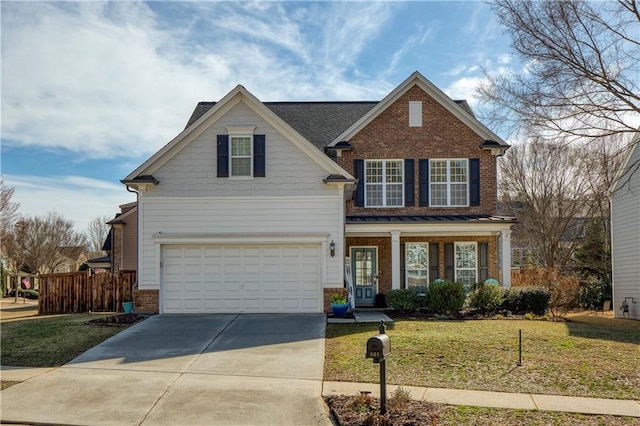 view of front property featuring a garage, a front lawn, and covered porch