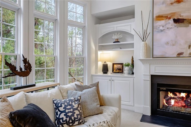 living room featuring light colored carpet and built in features