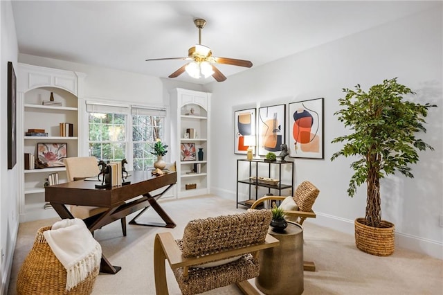 carpeted office featuring ceiling fan