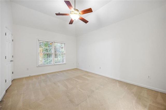 carpeted empty room featuring ceiling fan and vaulted ceiling