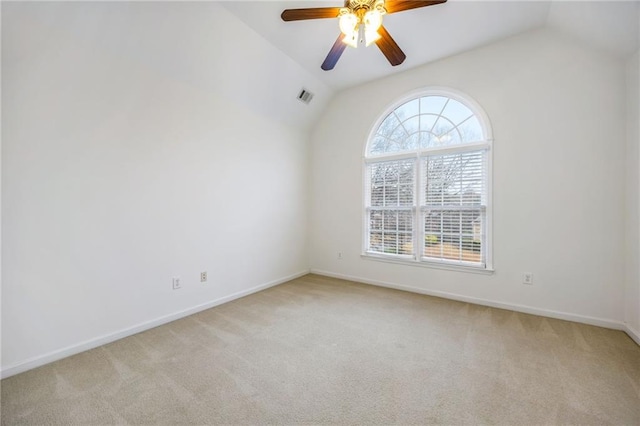 empty room with lofted ceiling, plenty of natural light, and light colored carpet