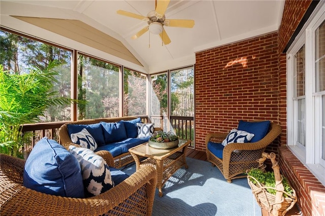 sunroom / solarium featuring lofted ceiling and ceiling fan