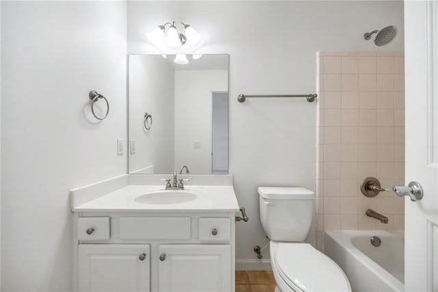 full bathroom with vanity, tiled shower / bath, tile patterned floors, and toilet