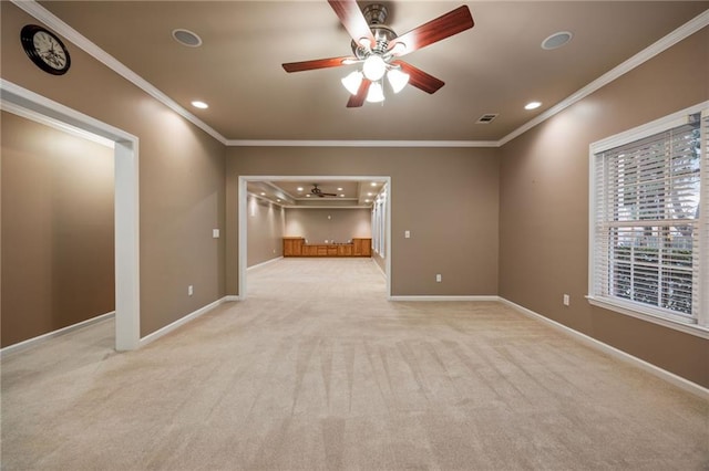 carpeted empty room with ceiling fan and ornamental molding