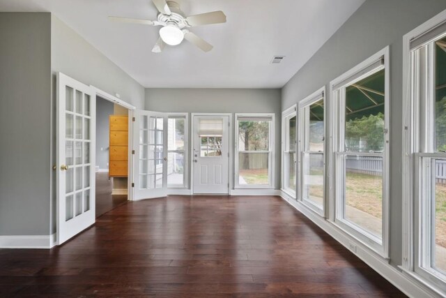 unfurnished sunroom featuring visible vents, french doors, and a ceiling fan