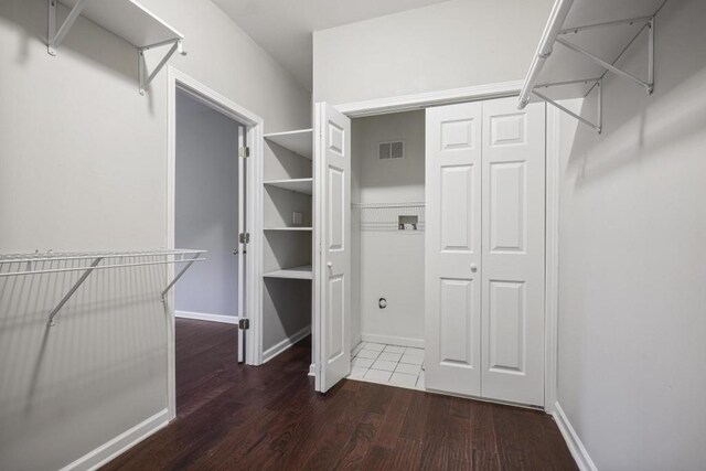 walk in closet with visible vents and wood finished floors