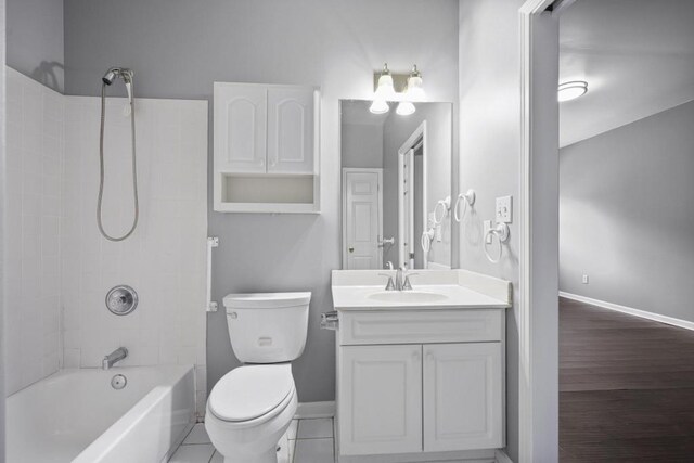 full bath featuring vanity, toilet, shower / bath combination, and baseboards