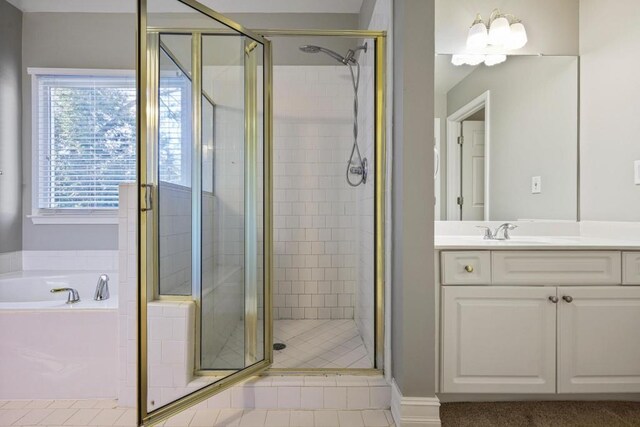 bathroom with vanity, a bath, and a stall shower