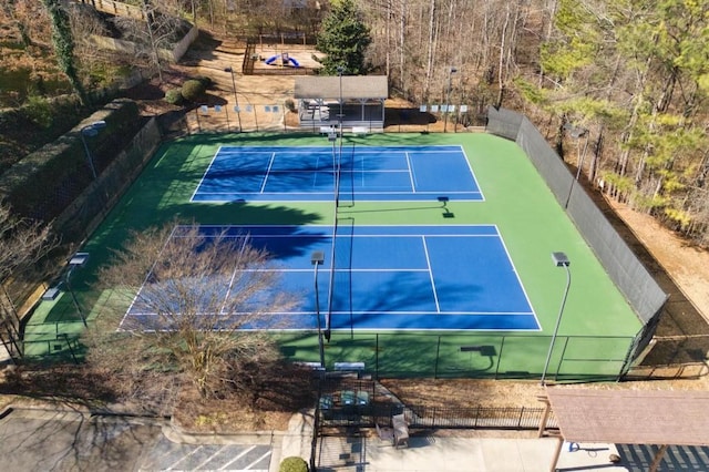 view of sport court featuring fence