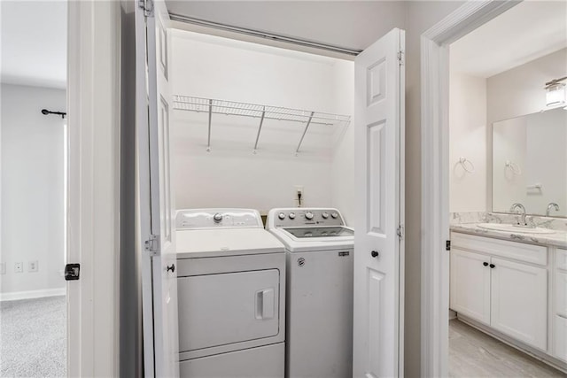 laundry area featuring laundry area, washing machine and dryer, and a sink