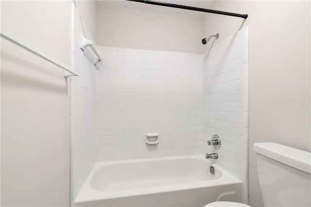 bathroom featuring tub / shower combination and toilet