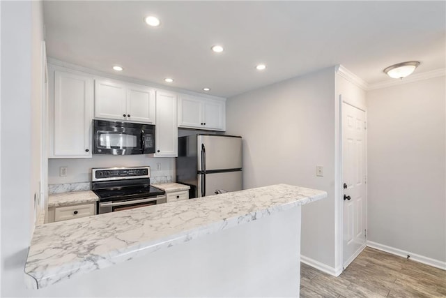 kitchen featuring recessed lighting, light wood-style flooring, appliances with stainless steel finishes, ornamental molding, and white cabinets