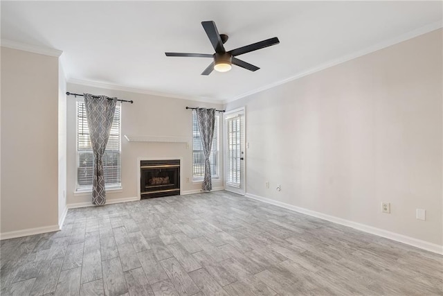 unfurnished living room featuring light wood-style floors, a fireplace, baseboards, and ornamental molding