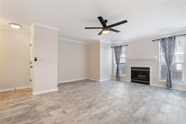 unfurnished living room featuring light wood finished floors, a fireplace, a ceiling fan, and crown molding