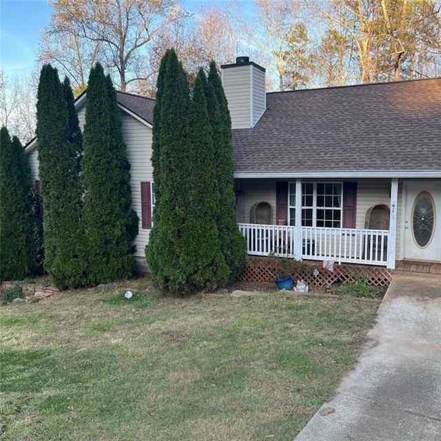 view of front of house with a front yard and a porch