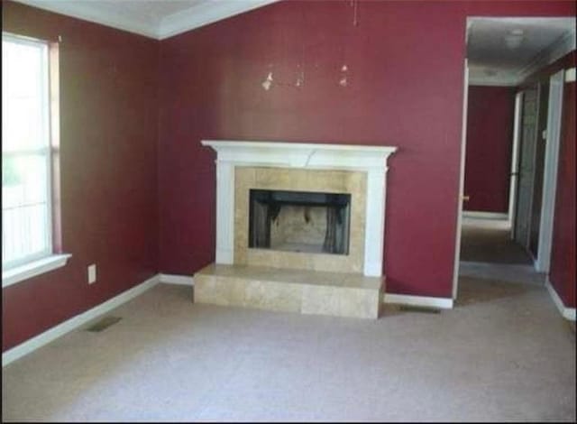 unfurnished living room with carpet flooring and a high end fireplace