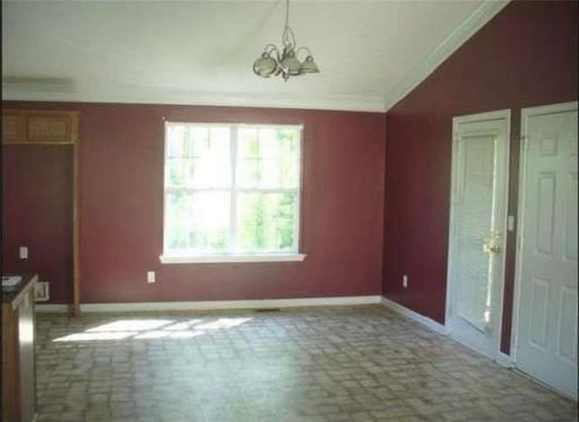 interior space featuring crown molding and a chandelier